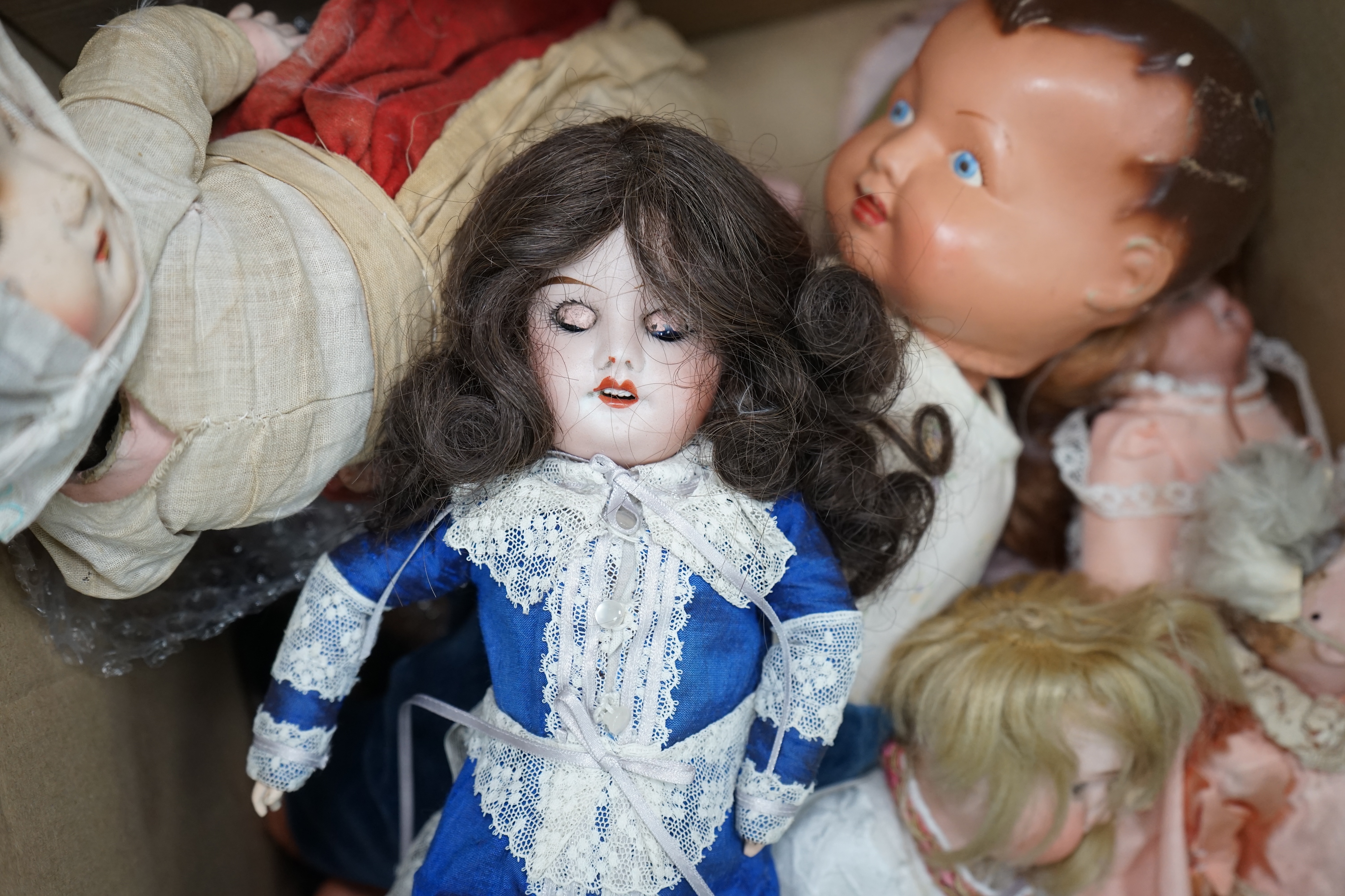 An Armand Marseille bisque doll, mould 390, a small Hermann Steiner bisque doll, three other bisque dolls including an SFBJ 60, and four composition dolls, Armand Marseille 33cm. Condition - poor to fair